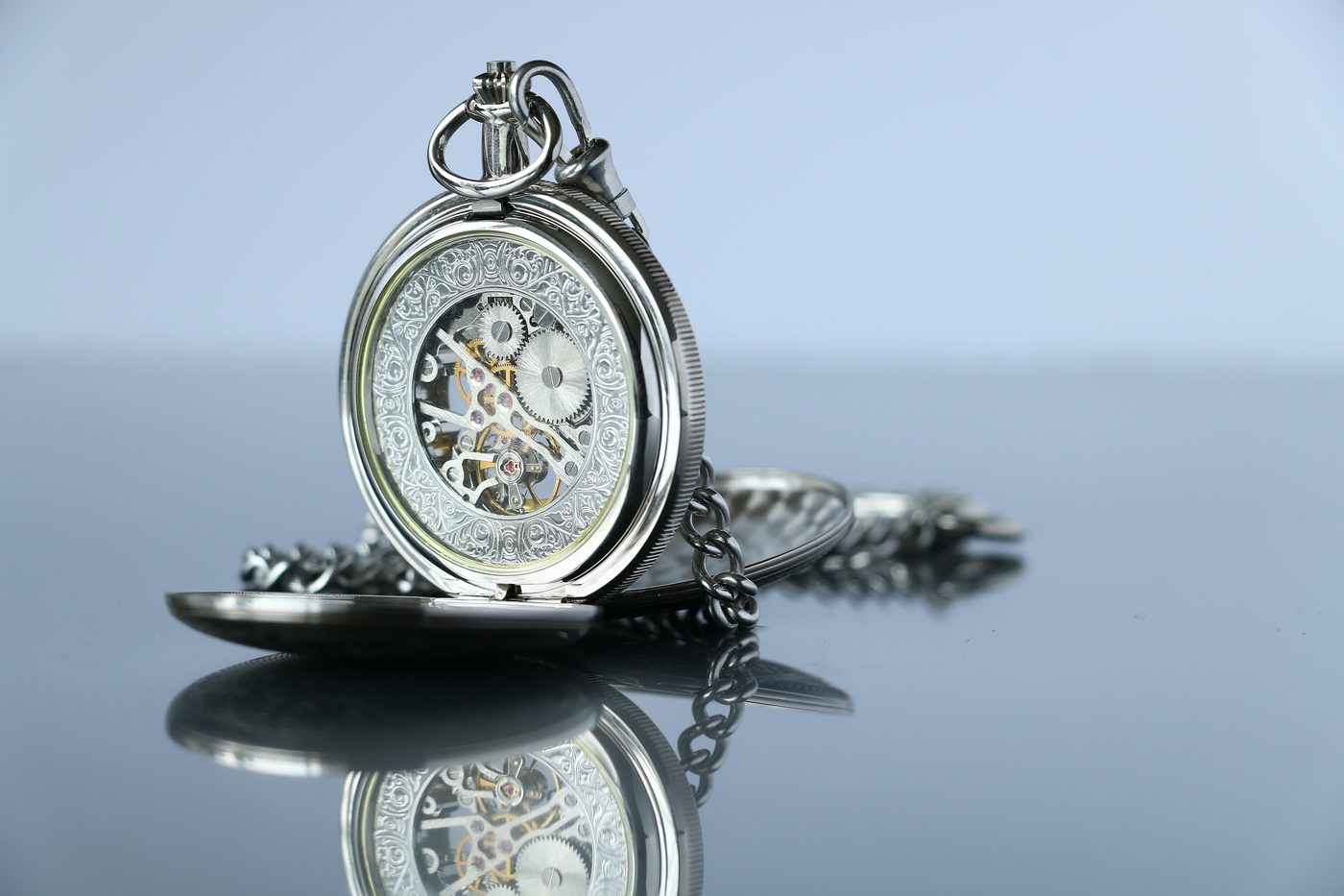 Pocket watch on a reflective surface