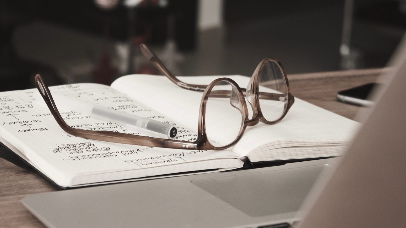Glasses resting on printed research papers